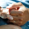 person wearing gold wedding band